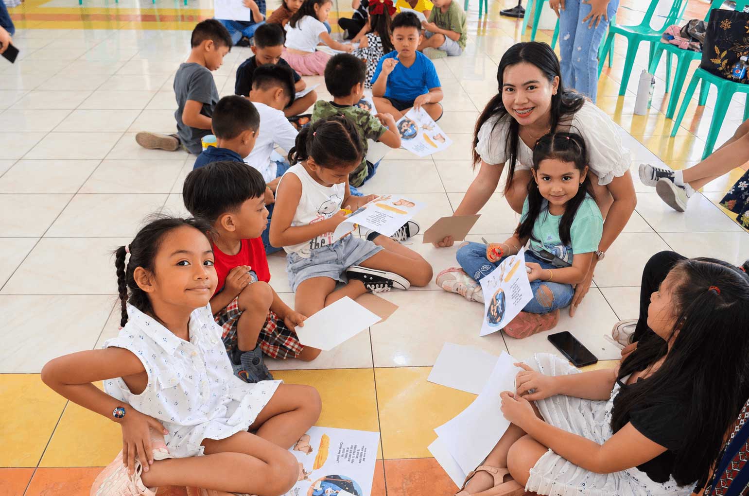 A group of smiling children gathered close together