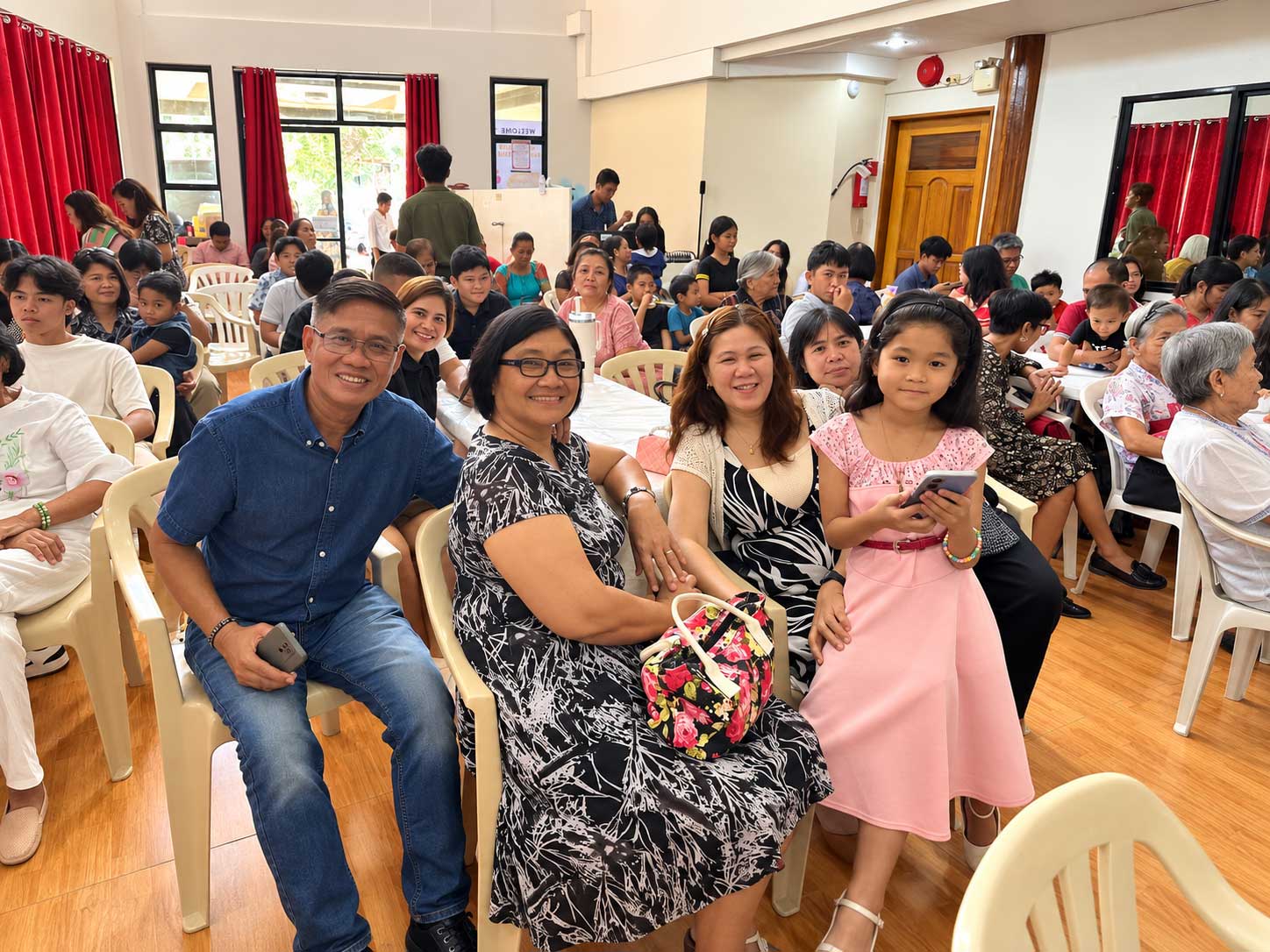 A group of friends sitting side by side, arms around each other